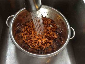 Rinsing nuts under tap water